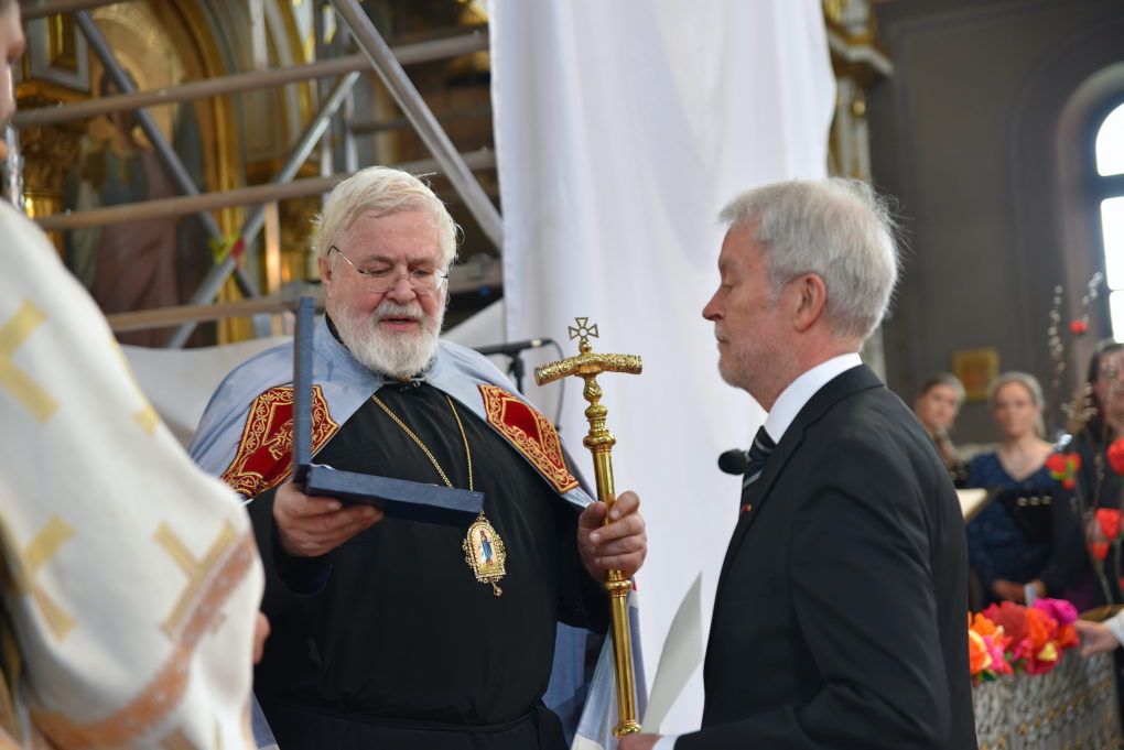 Arkkipiispa Leo ojentaa Aleksi Härköselle Pyhän Karitsan ritarikunnan 1. luokan komentajamerkin.